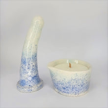 Load image into Gallery viewer, A 6 inch curved ceramic dildo and a matching massage candle in a dark blue to light blue speckle pattern stand in a white photo booth.