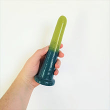 Load image into Gallery viewer, A hand holds a 7 inch classic ceramic dildo in a dark green to light green gradient pattern in front of a white background.

